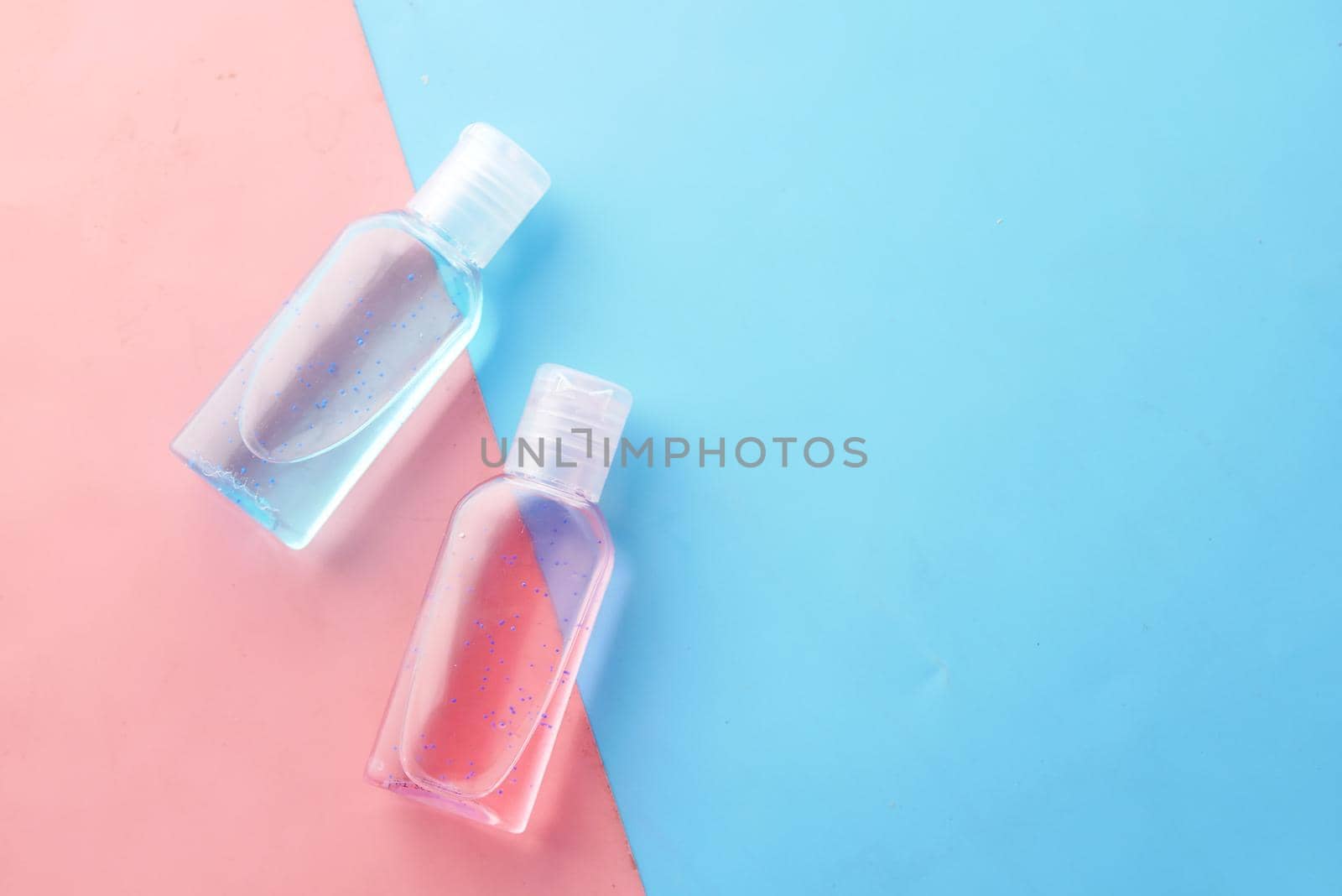 hand sanitizer liquid in a plastic bottle on color background .