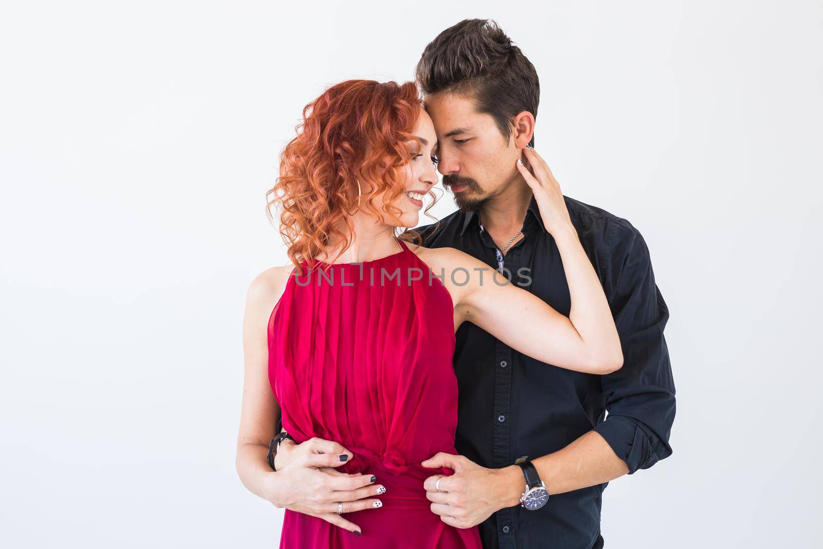Social dance, bachata, kizomba, salsa, tango concept - Close up portrait of woman man dressed in beautiful outfits over white background.