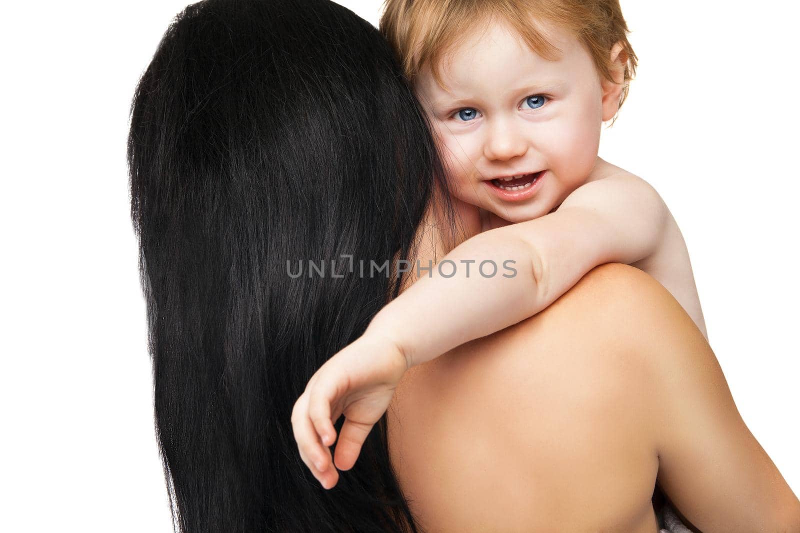 Young mother with her baby after bathing in a white towel