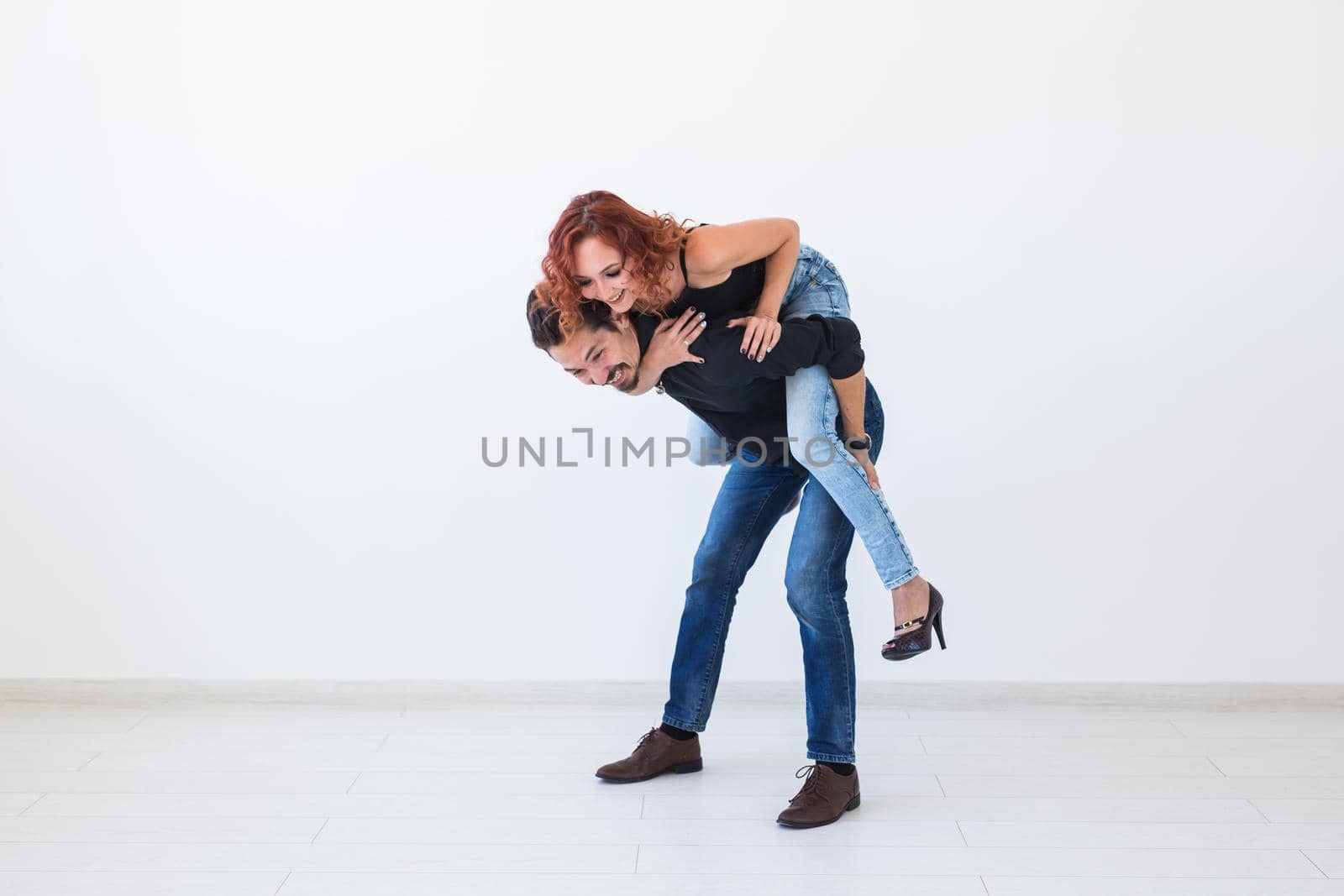 Friendship, people concept - young woman jumped on the man's back by Satura86