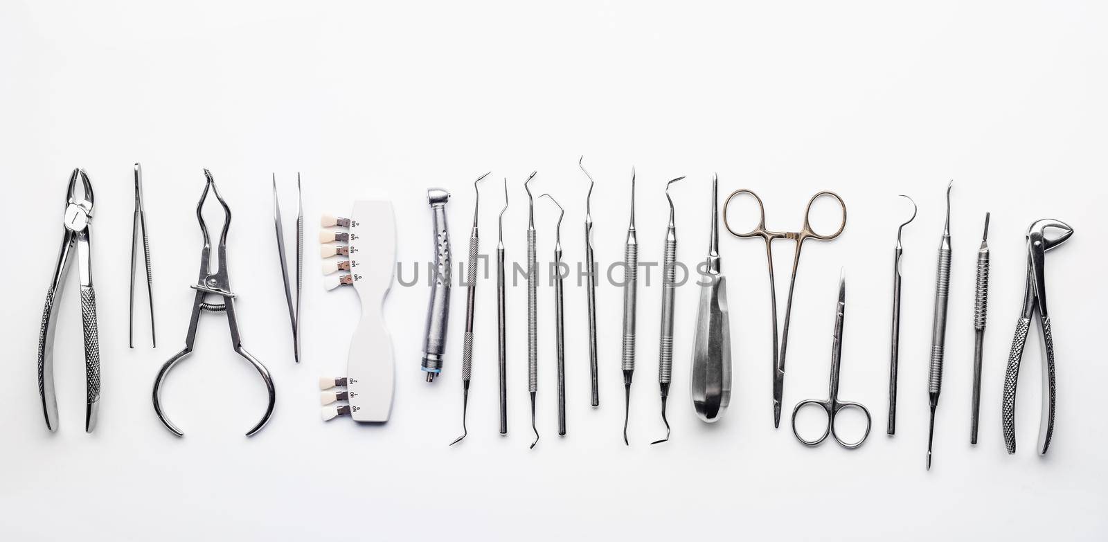 Different dental metal tools on white table