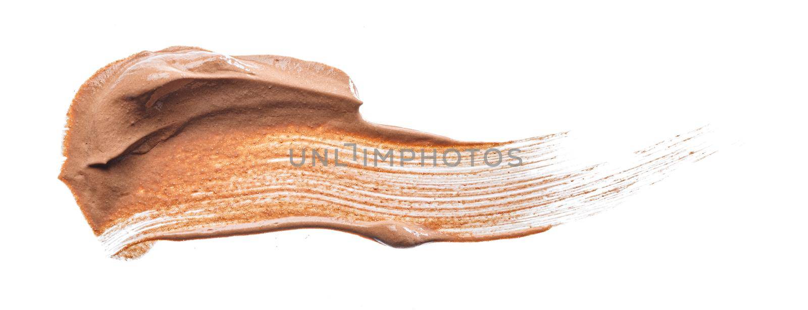 Smudged stain of a cream foundation isolated on white, close up.