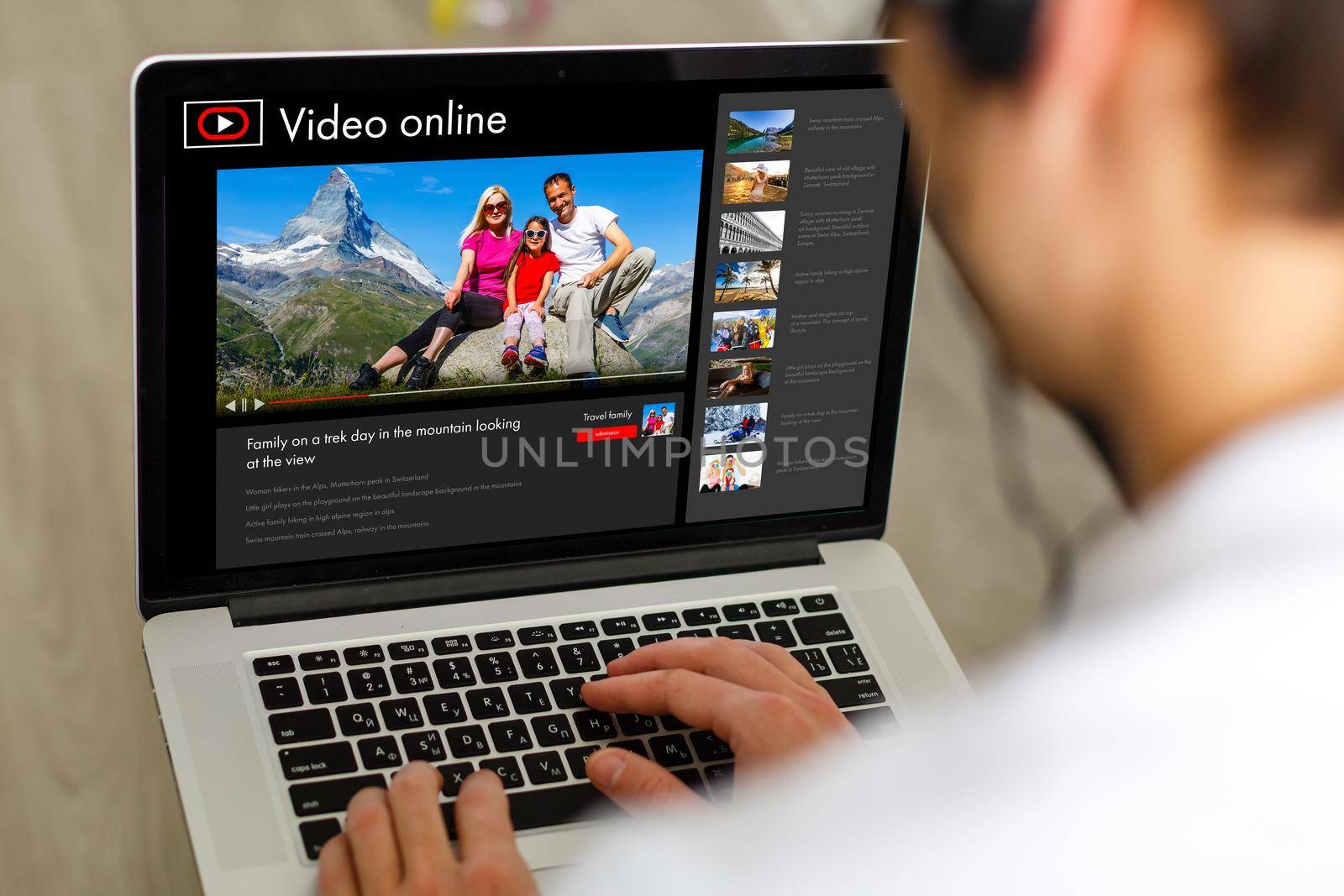 man searching information for planning future trip, making booking of hotel on website using internet indoors, a man watching a video about a trip online on a laptop.