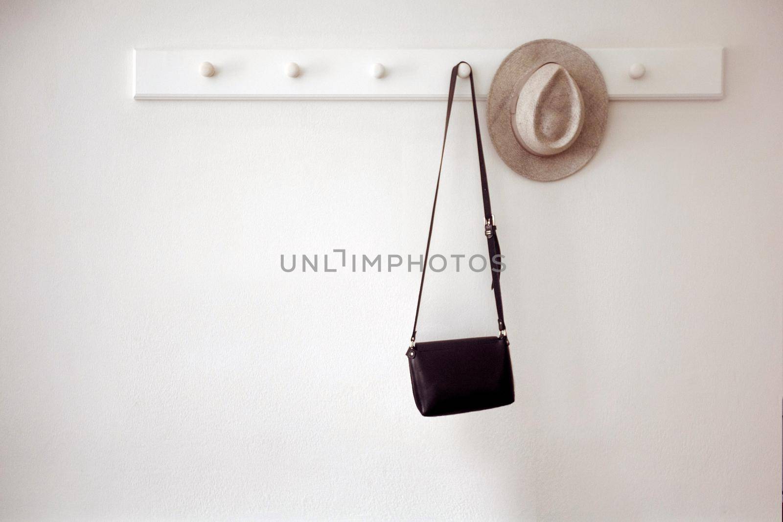 Hat and bag hanging on pegs by Demkat
