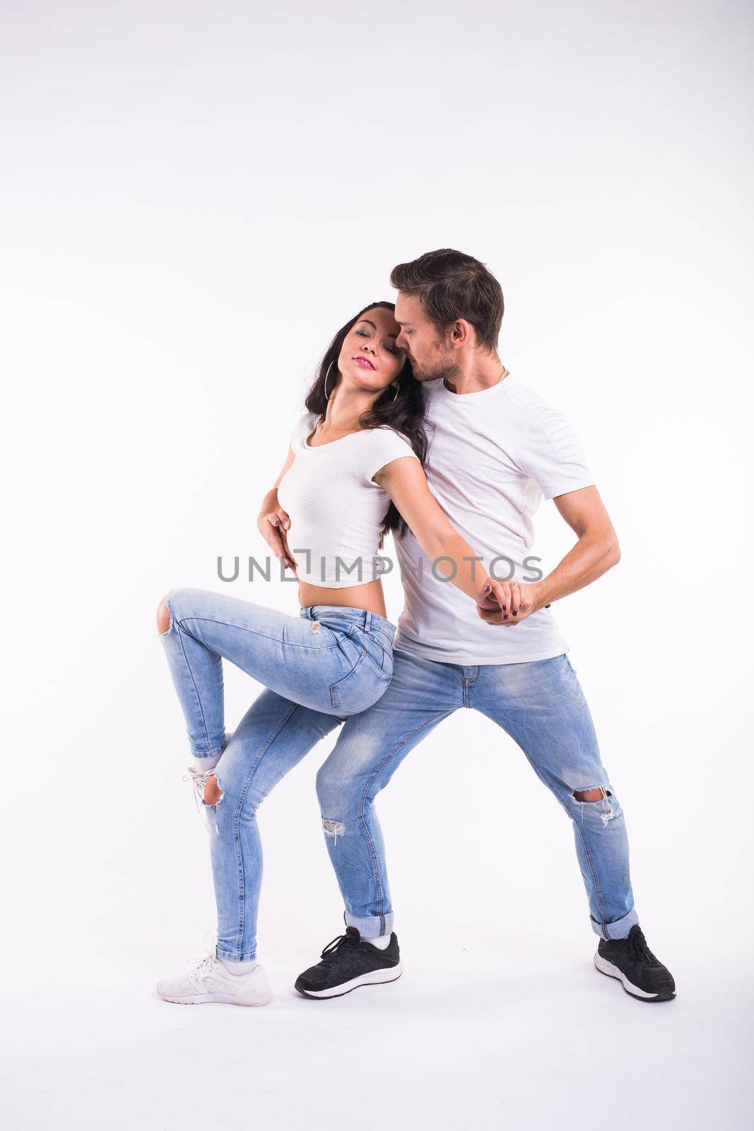 Passionate couple dancing social danse kizomba or bachata or semba or taraxia on white background by Satura86