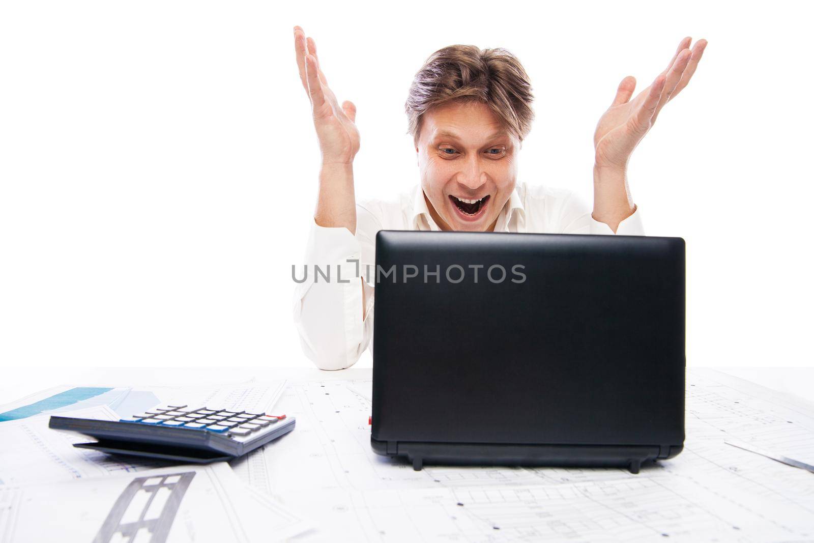 Happy young man in formal wear looking at laptop and gesturing