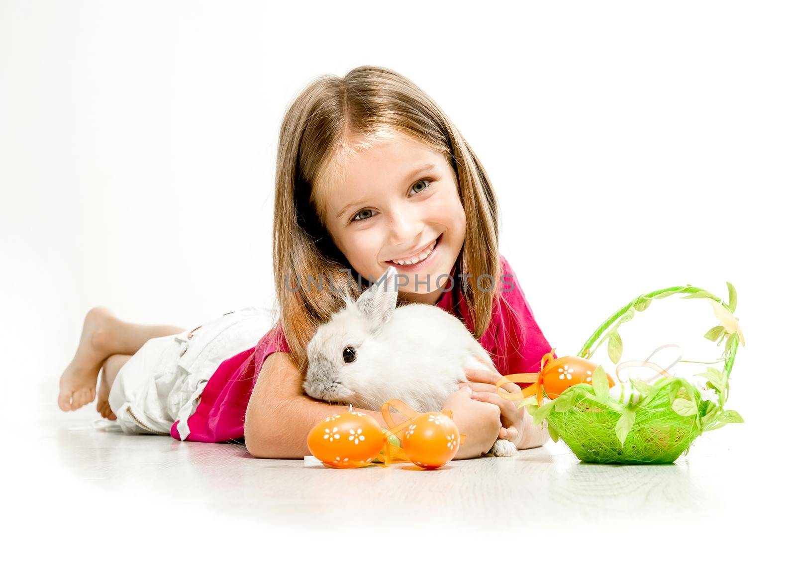 smiling little girl with a small white rabbit