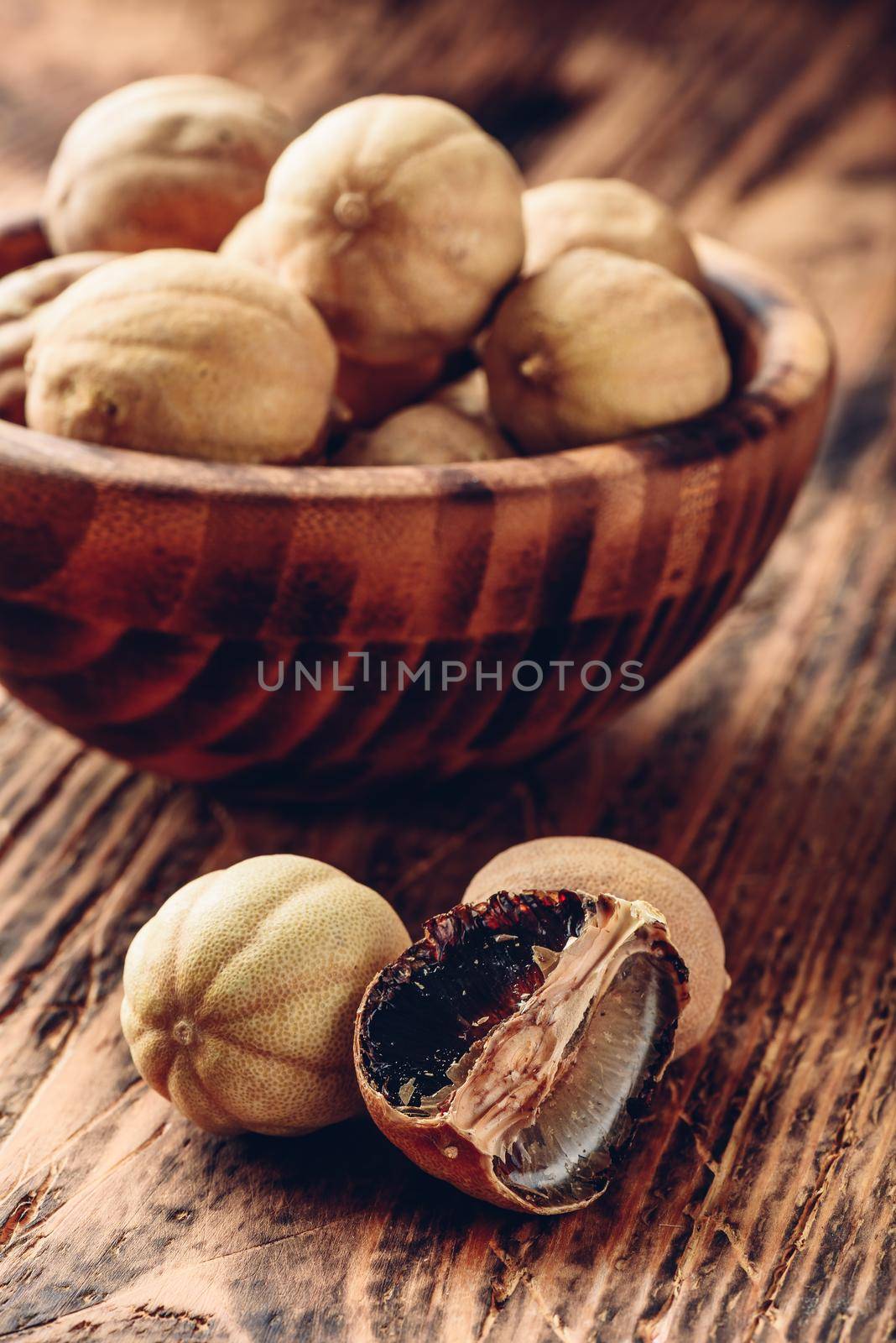 Dried limes on wooden table by Seva_blsv