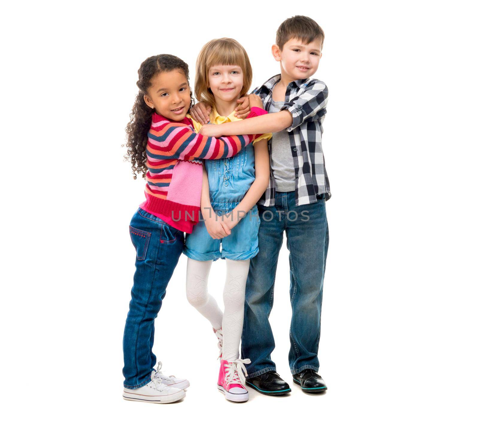 three smiling little children standing together isolated on white background