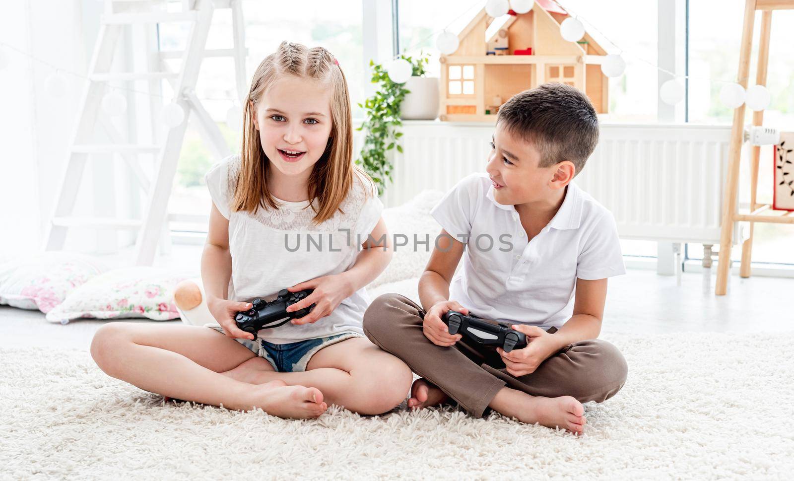 Playful kids with joysticks for gaming by tan4ikk1