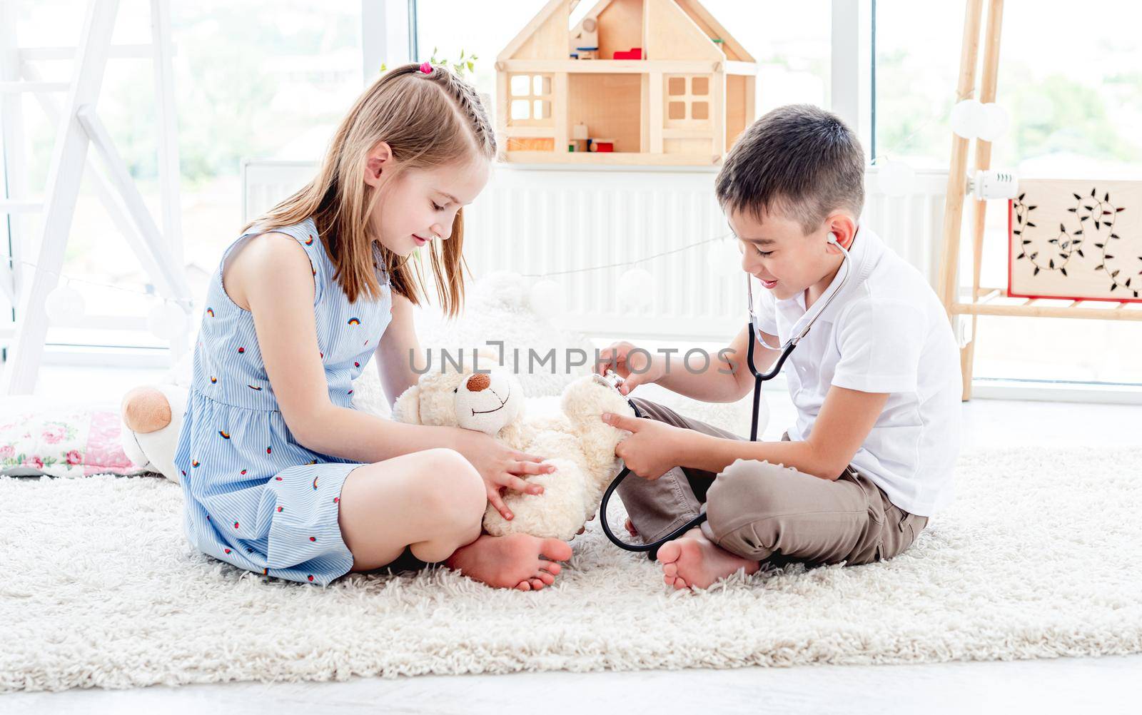 Children playing doctor with teddy bear by tan4ikk1