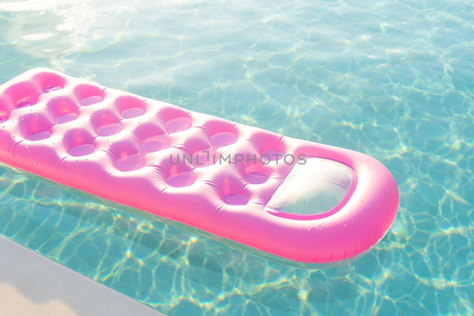 pink mattress in the swimming pool sunny day by Andelov13