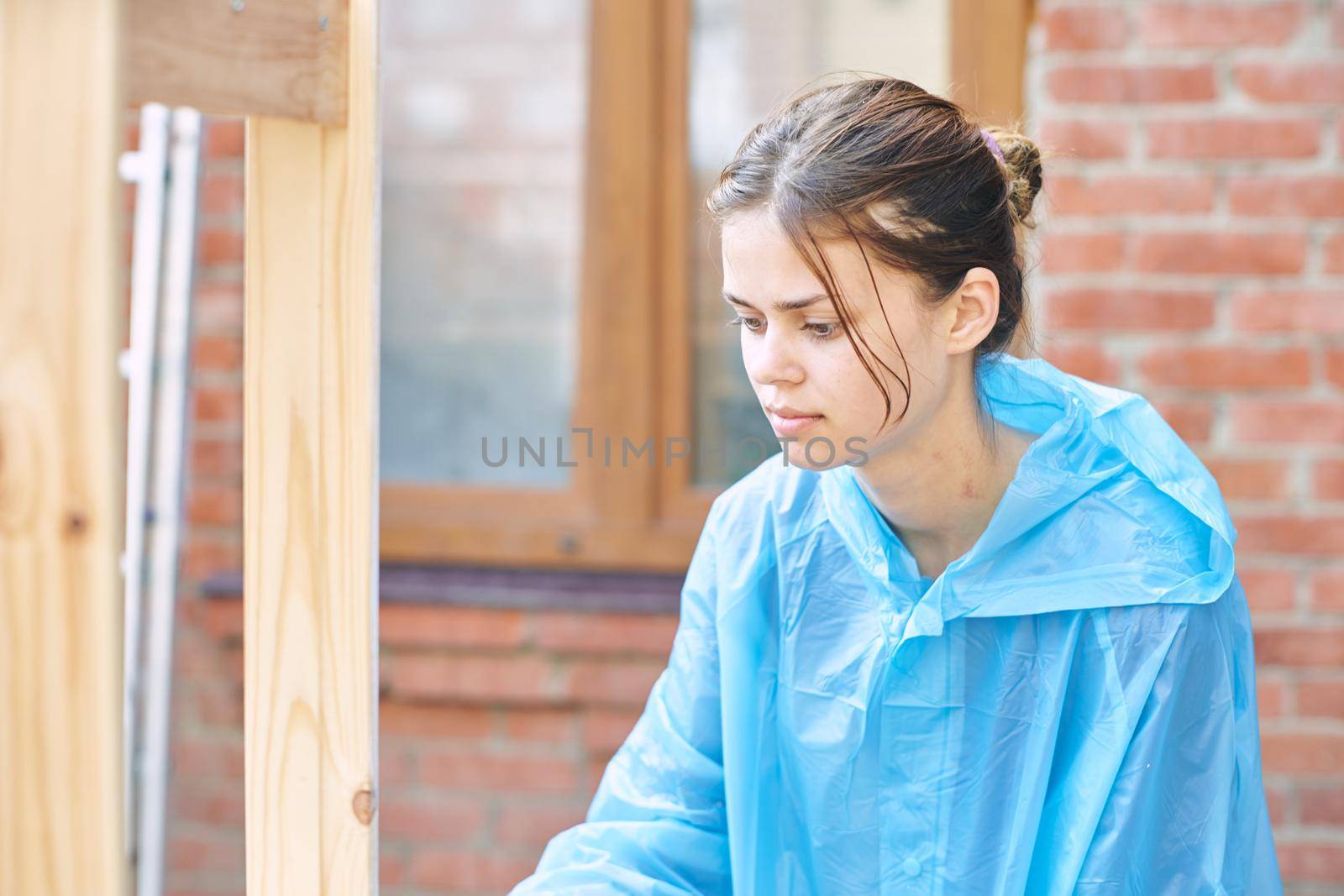 woman painter painting wood home renovation texture. High quality photo