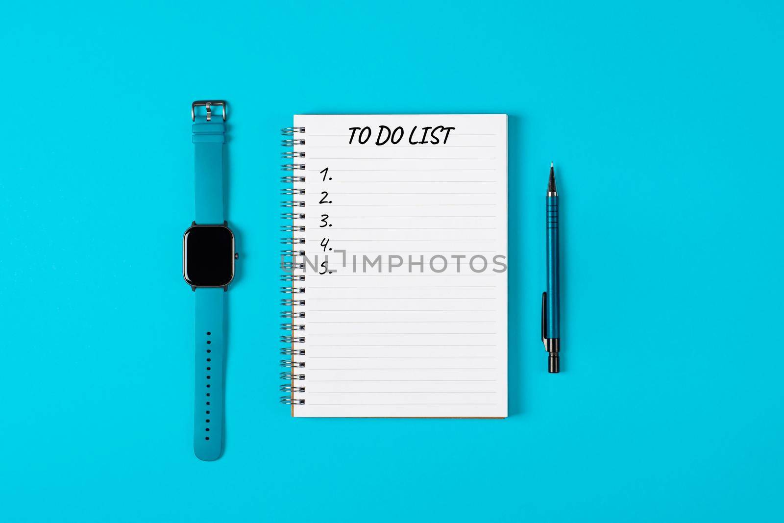 To do list banner. A watch, pencil and modern notebook isolated on blue background from above. Planning and design concept. Top view, flat lay, copy space