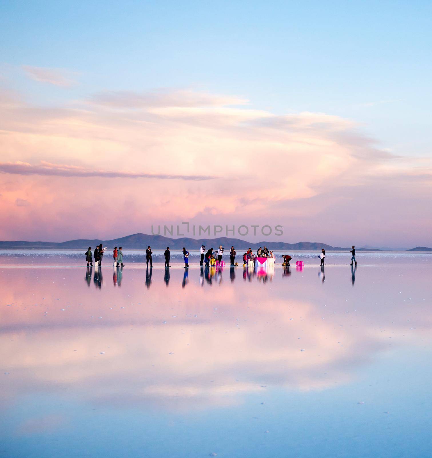 Bolivia - October 21, 2018: Tourists on mirrored salt flats by tan4ikk1