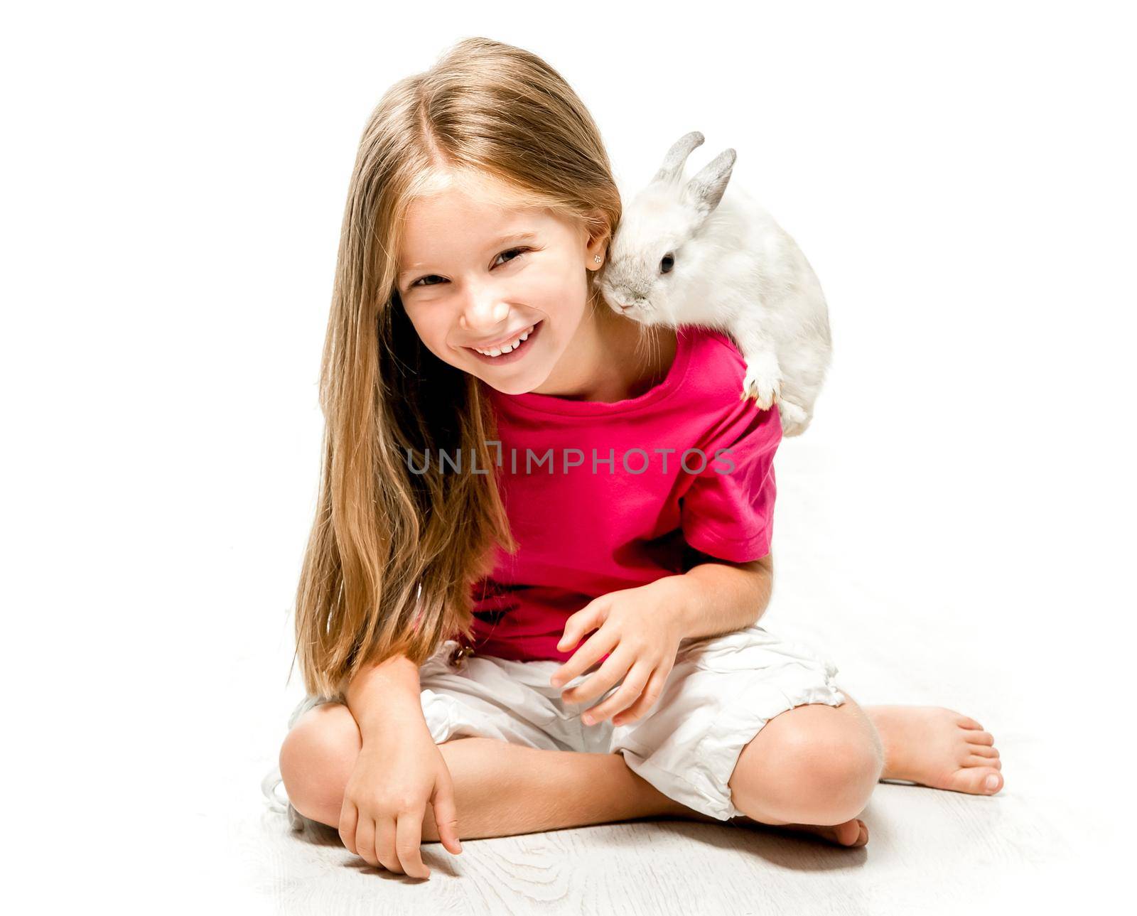smiling little girl with a small white rabbit