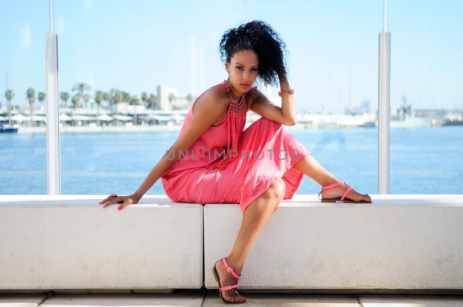 Black woman with pink dress and earrings. Afro hairstyle by javiindy