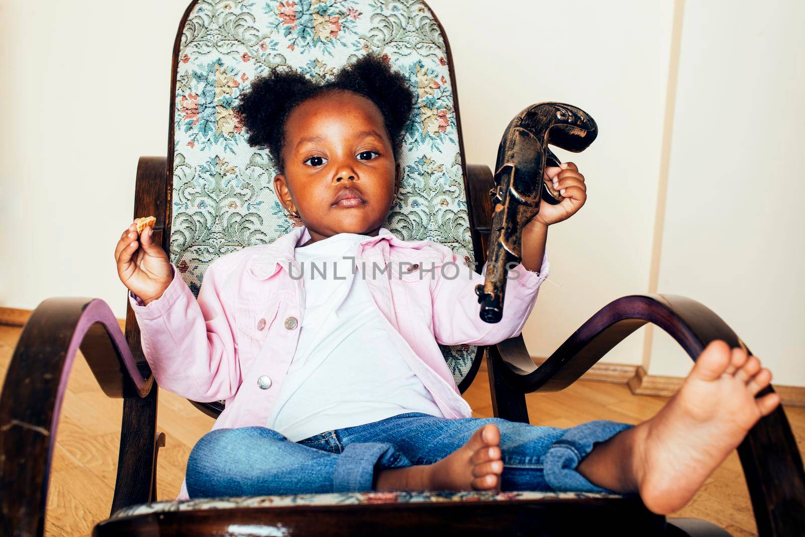 little cute african american girl playing with animal toys at home, pretty adorable princess in interior happy smiling, lifestyle real people concept close up