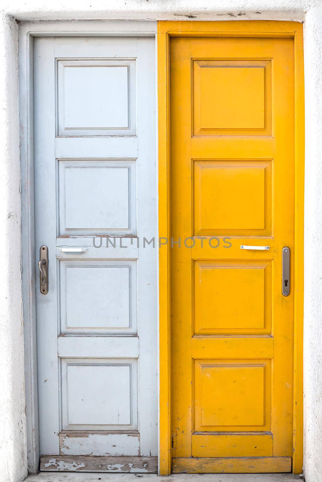 Traditional colorful rustic white and yellow doors of Greek island