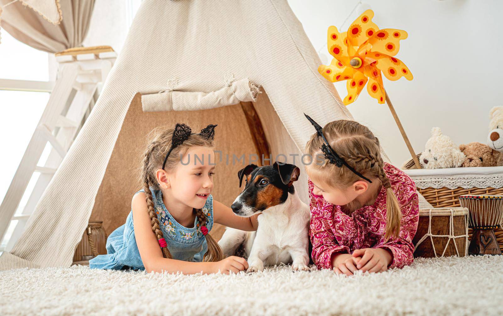 Children lying with dog in wigwam by tan4ikk1