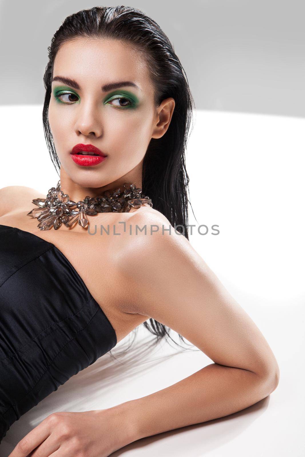 Fashion photo of young magnificent woman posing at studio