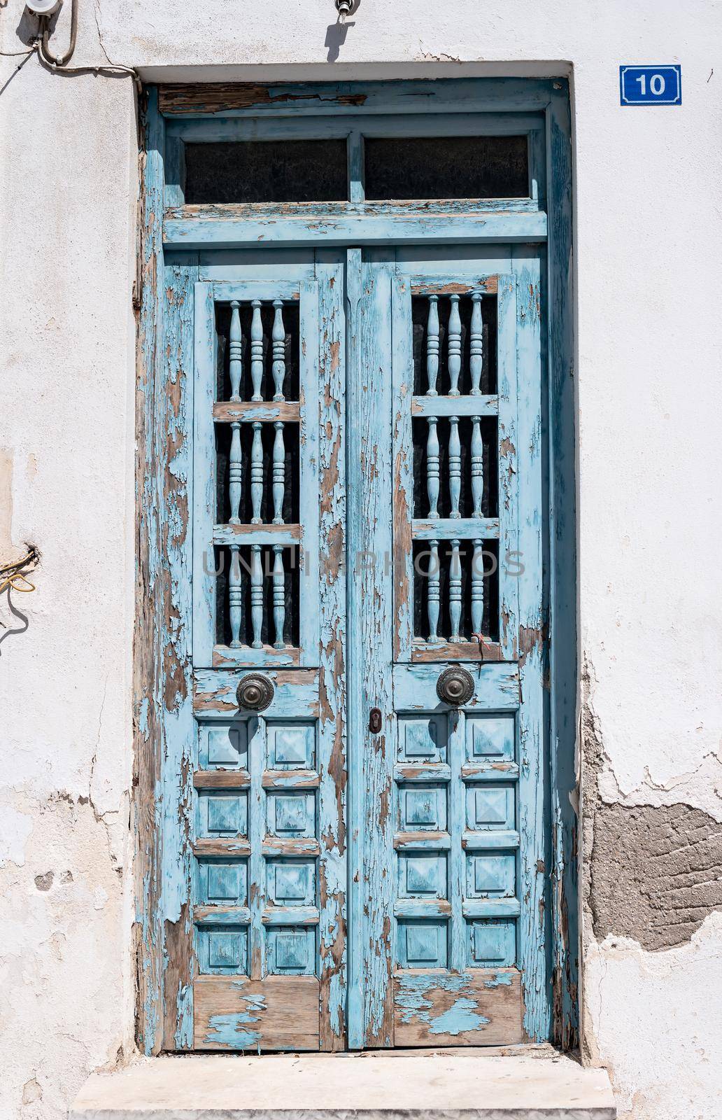 Vintage blue wooden door with cracked paint by tan4ikk1