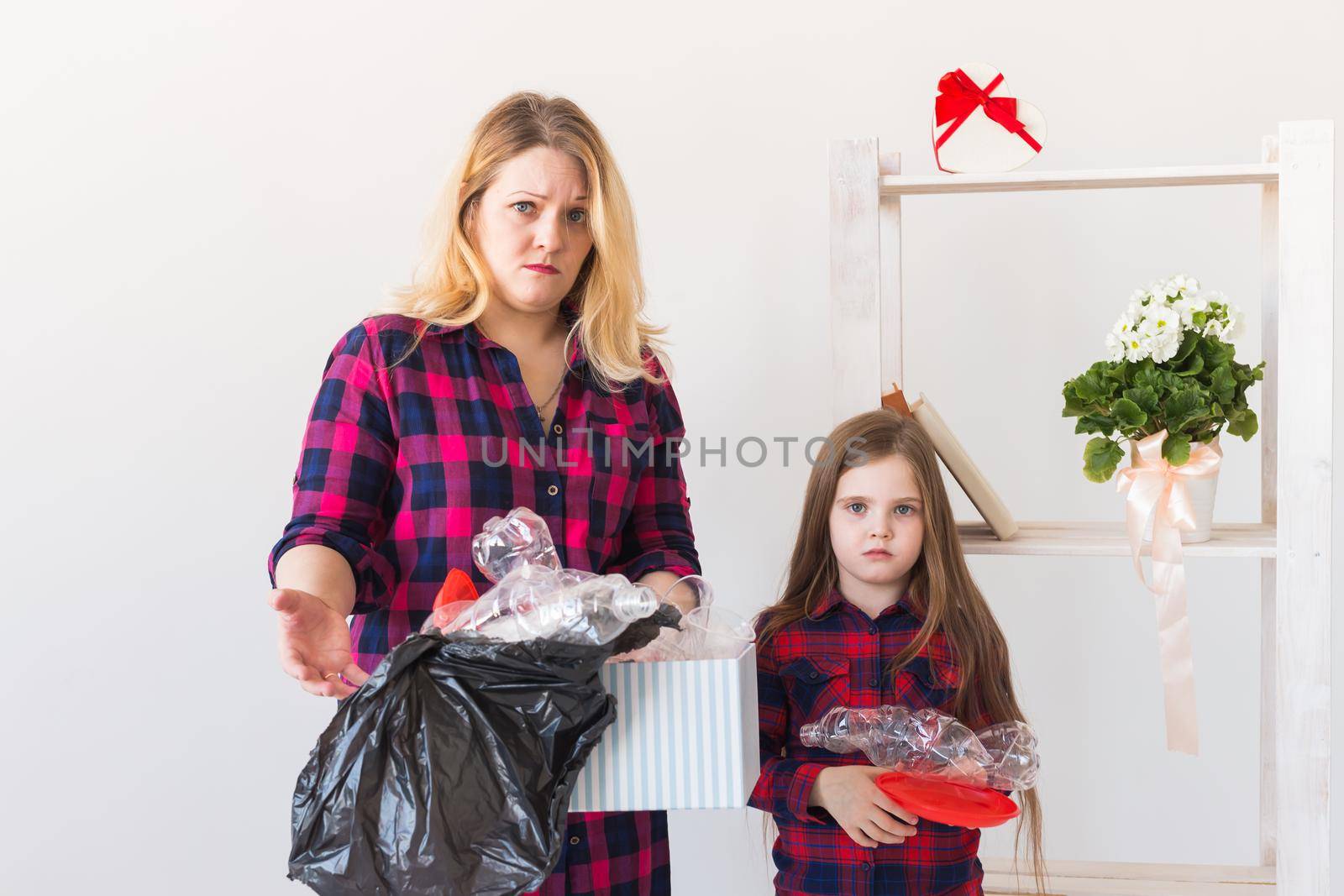 Environmental protection and pollution concept. Surprised woman holds box with plastic trash