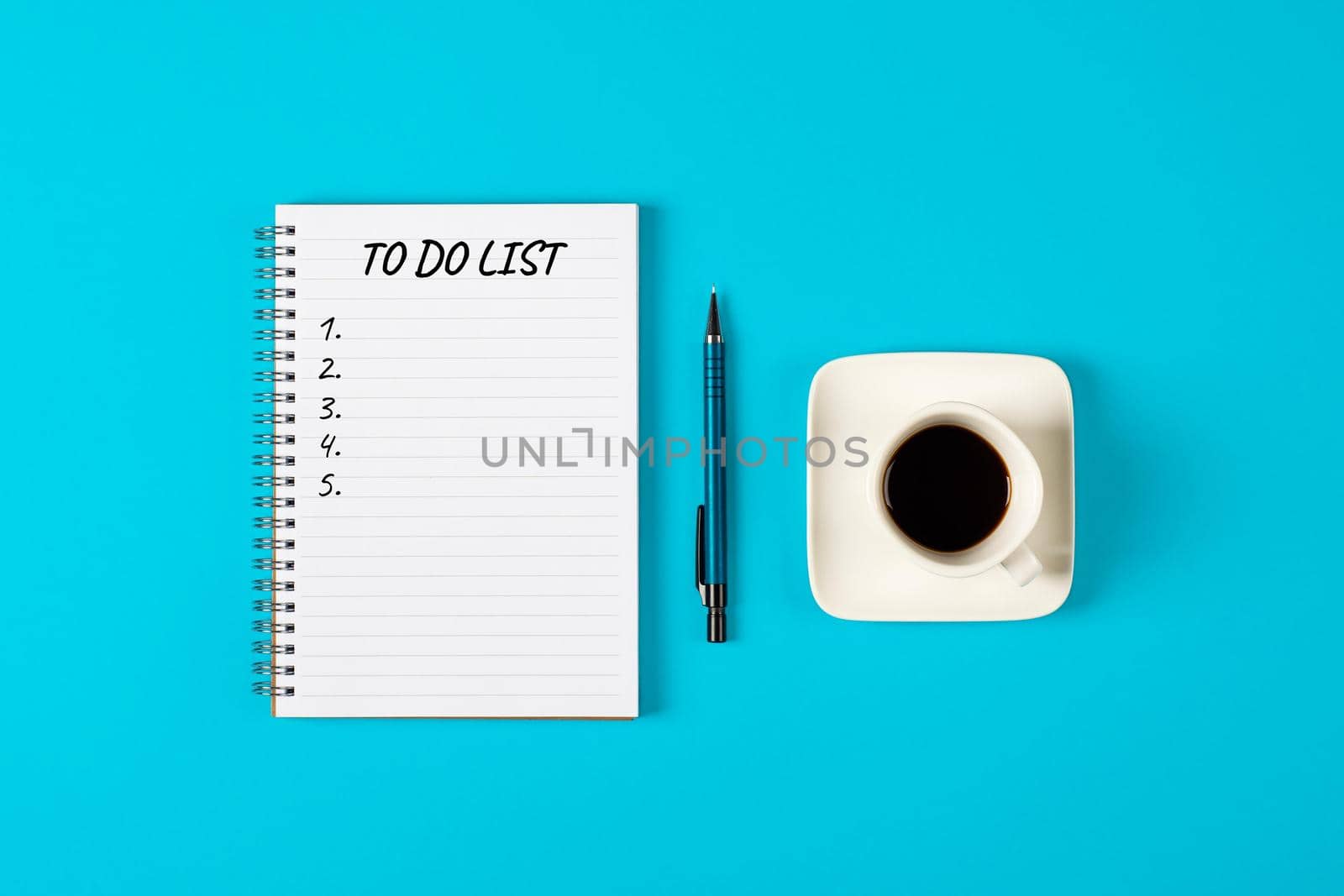 To do list banner. A cup of black coffee, pencil and modern notebook isolated on blue background from above. Planning and design concept. Top view, flat lay, copy space. by esvetleishaya