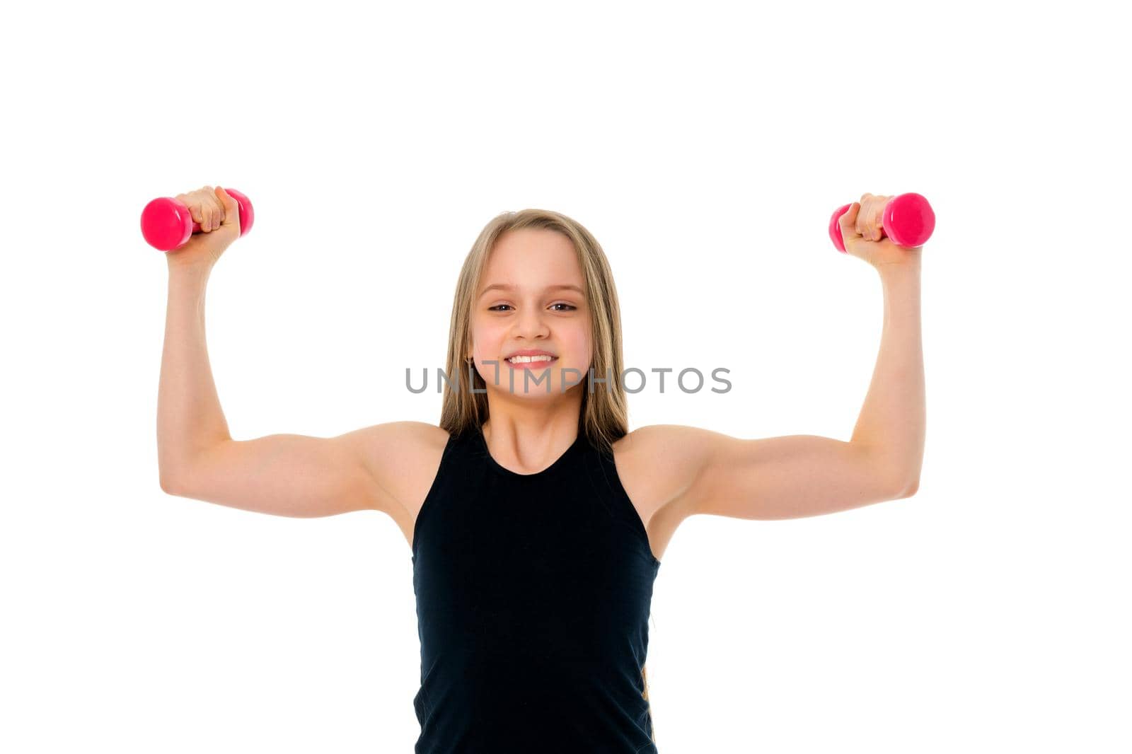 A cute little girl doing exercises with dumbbells. The concept of strength, health and sport. Isolated on white background.