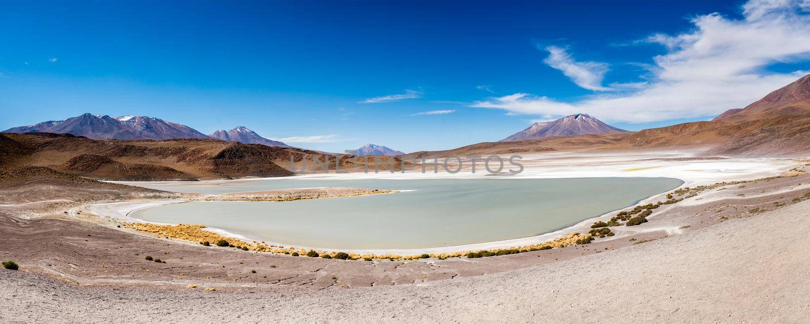 Amazing panoramic view of sunshine mountanious lagoon in Bolivia