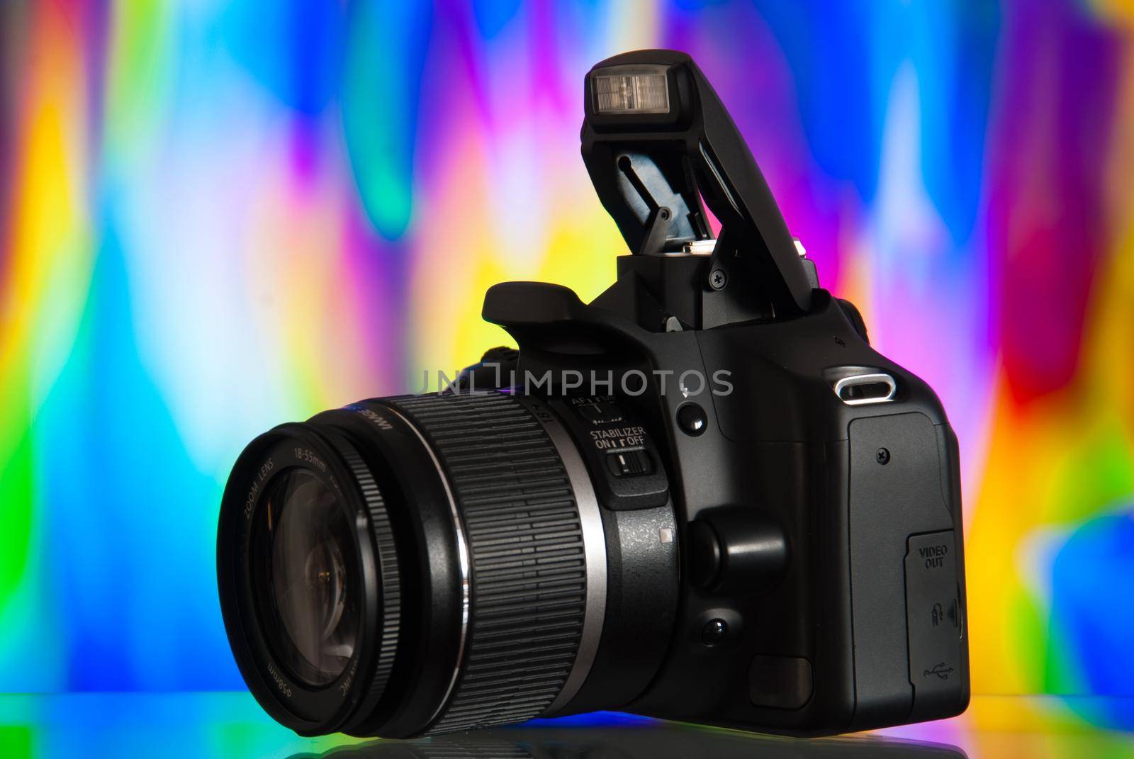 Dslr camera isolated on colorful background with reflection