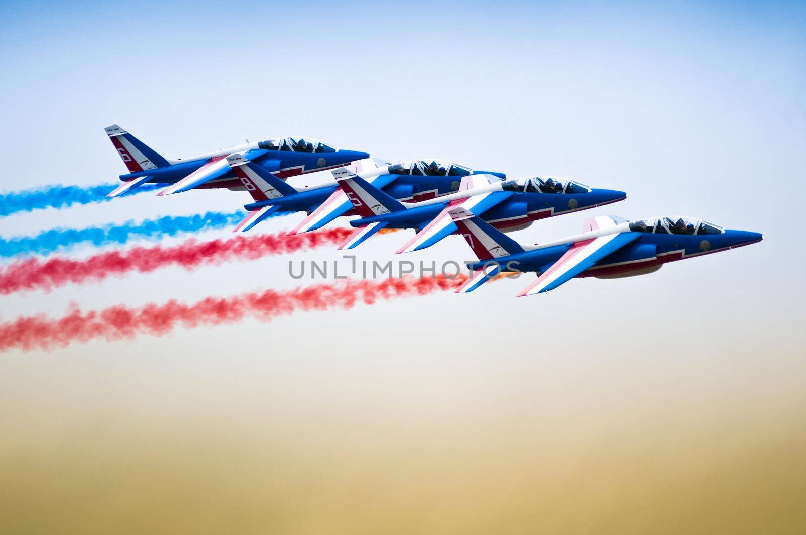 sport jet planes with colorful smoke exhaust