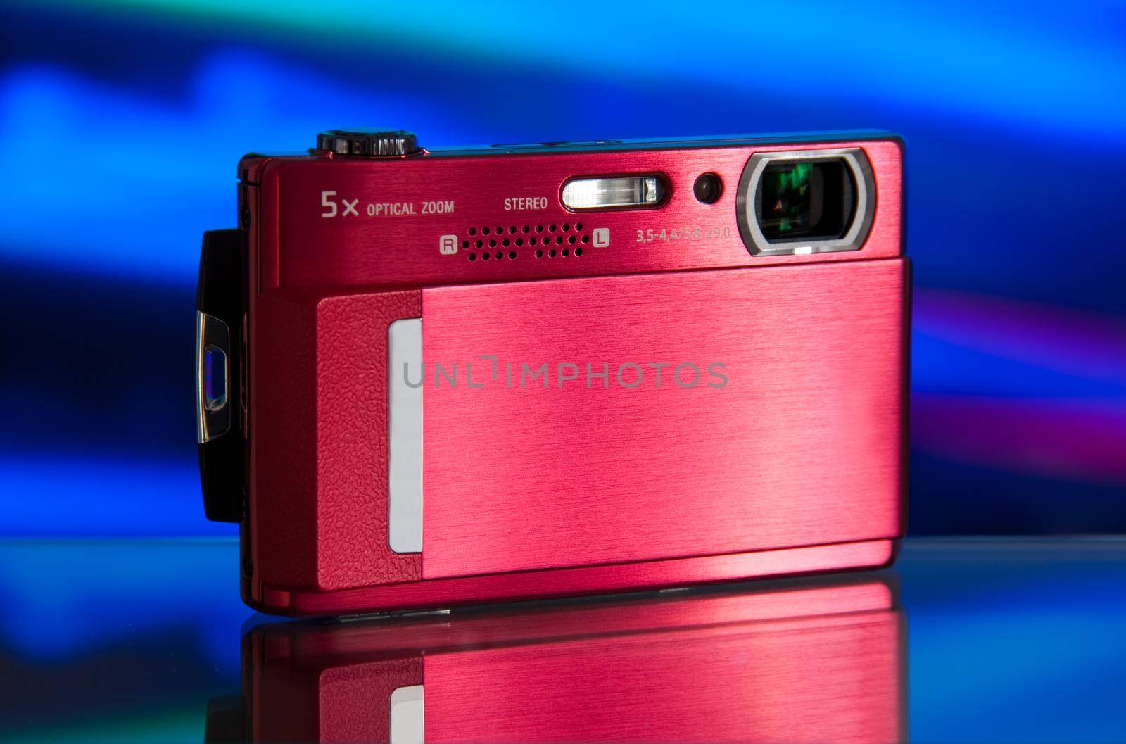 photo of the compact digital camera with beautiful background and glass reflection