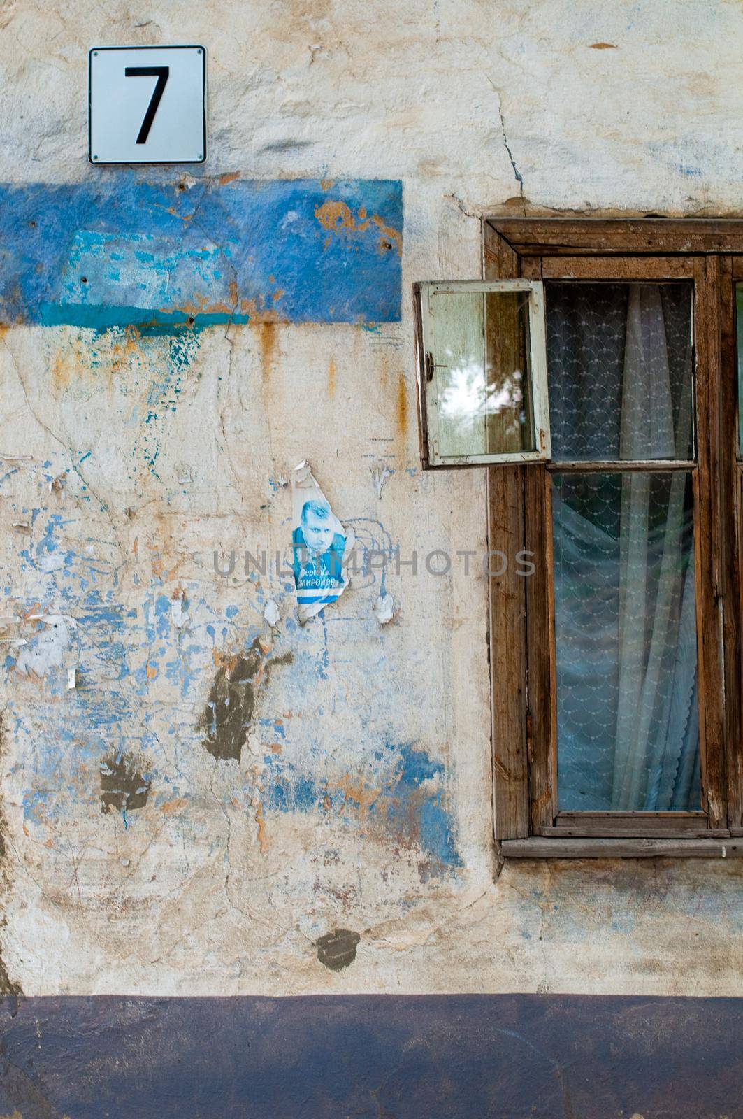 old window on facade of the old house