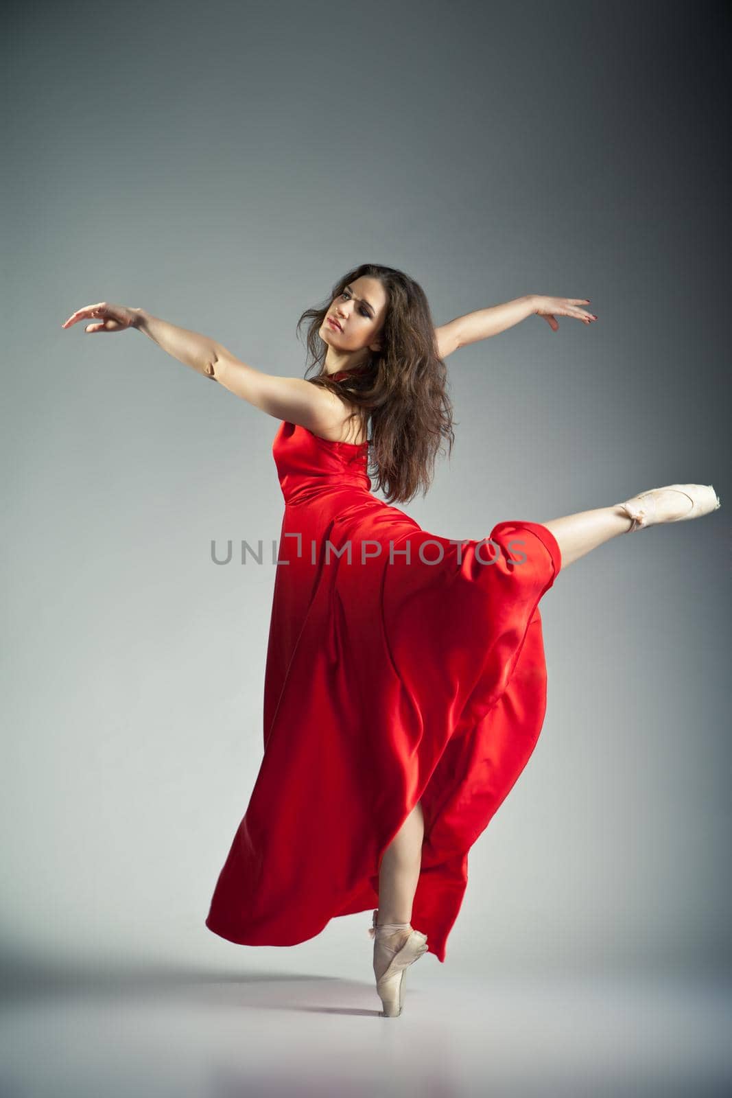 Ballet dancer wearing red dress over grey by Julenochek