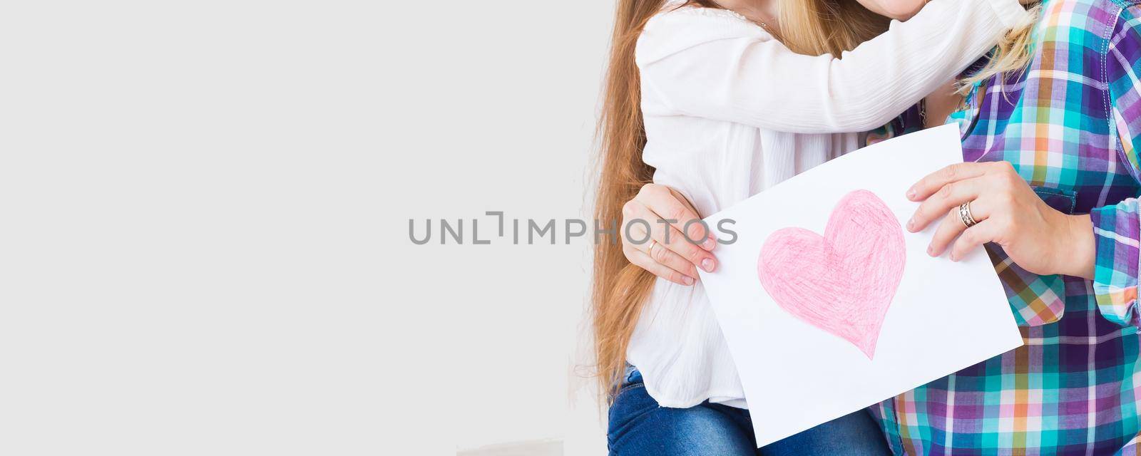 Mother's Day, holidays and family holidays - Mother holds greeting card from her lovely daughter, close-up banner with copy space by Satura86