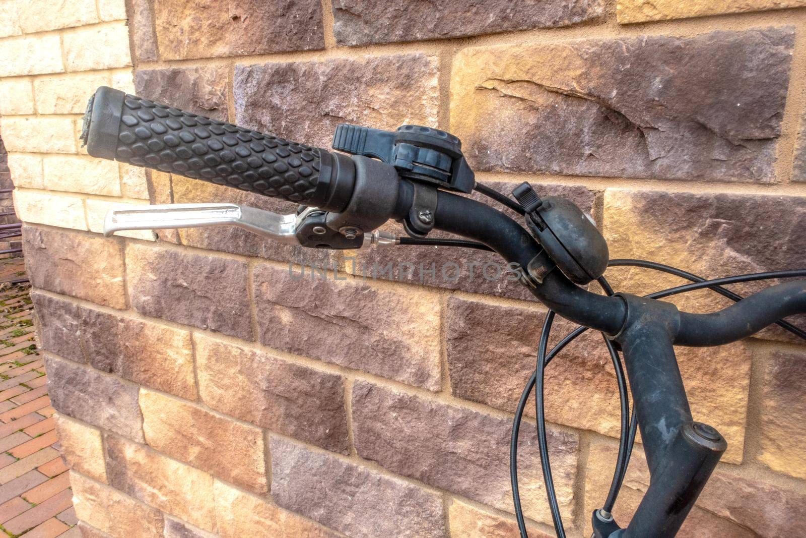 Close-up of a bicycle handlebar that leaned against the wall. The concept of travel, the dream of summer rest.