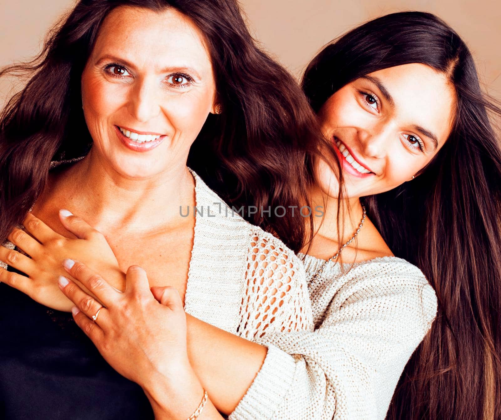 cute pretty teen daughter with mature mother hugging, fashion style brunette makeup close up tann s together, warm colors by JordanJ