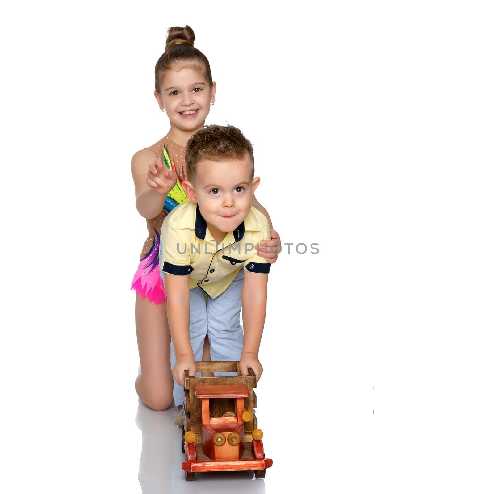 Brother and sister are playing with a toy car. The concept of happy childhood, people, harmonious development of the child in the family. Isolated on white background.