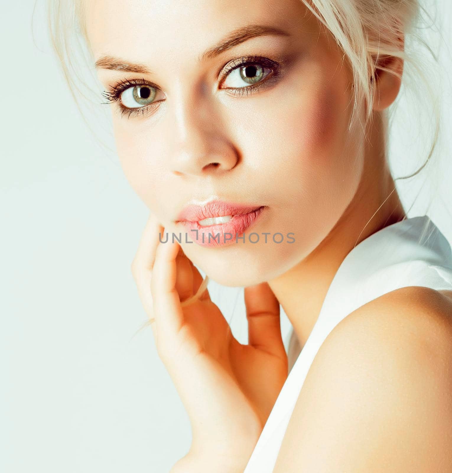 young pretty woman with blond hair on white background, sensual makeup, fashion sexy look, lifestyle people concept close up