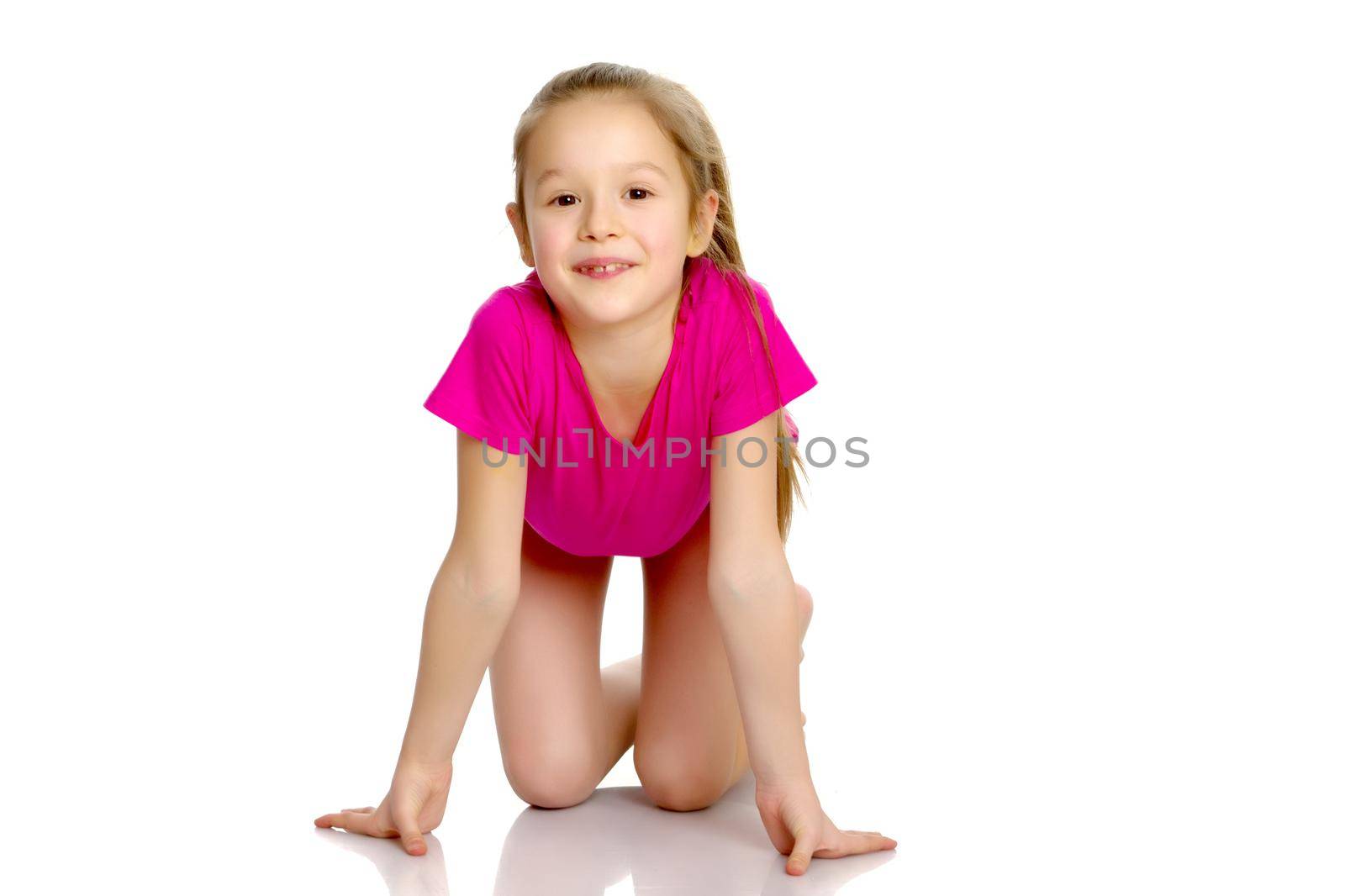 A gymnast girl prepares for the exercise. The concept of childhood and sport, a healthy lifestyle. Isolated on white background.