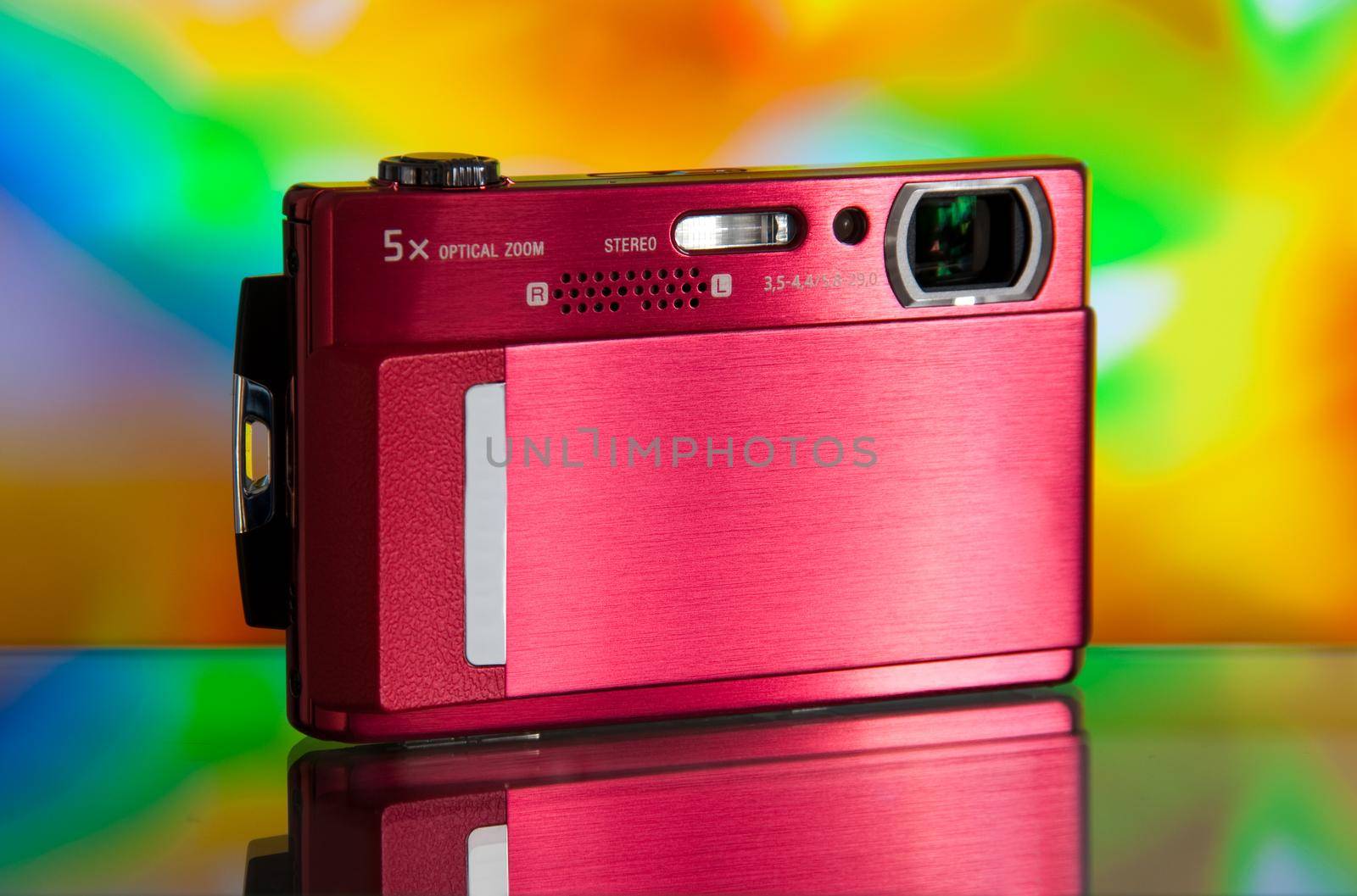 photo of the compact digital camera with beautiful background and glass reflection