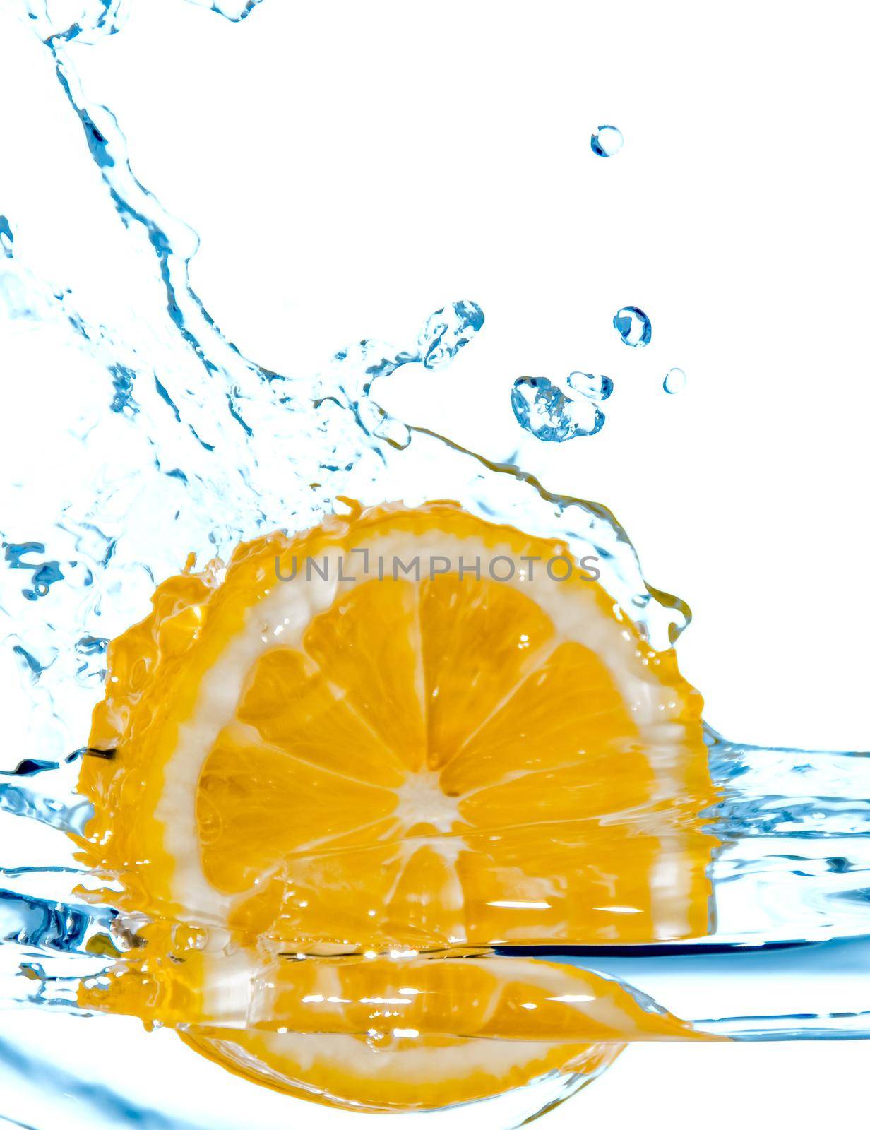 photo of the lemon slice fall in water with splash isolated on white