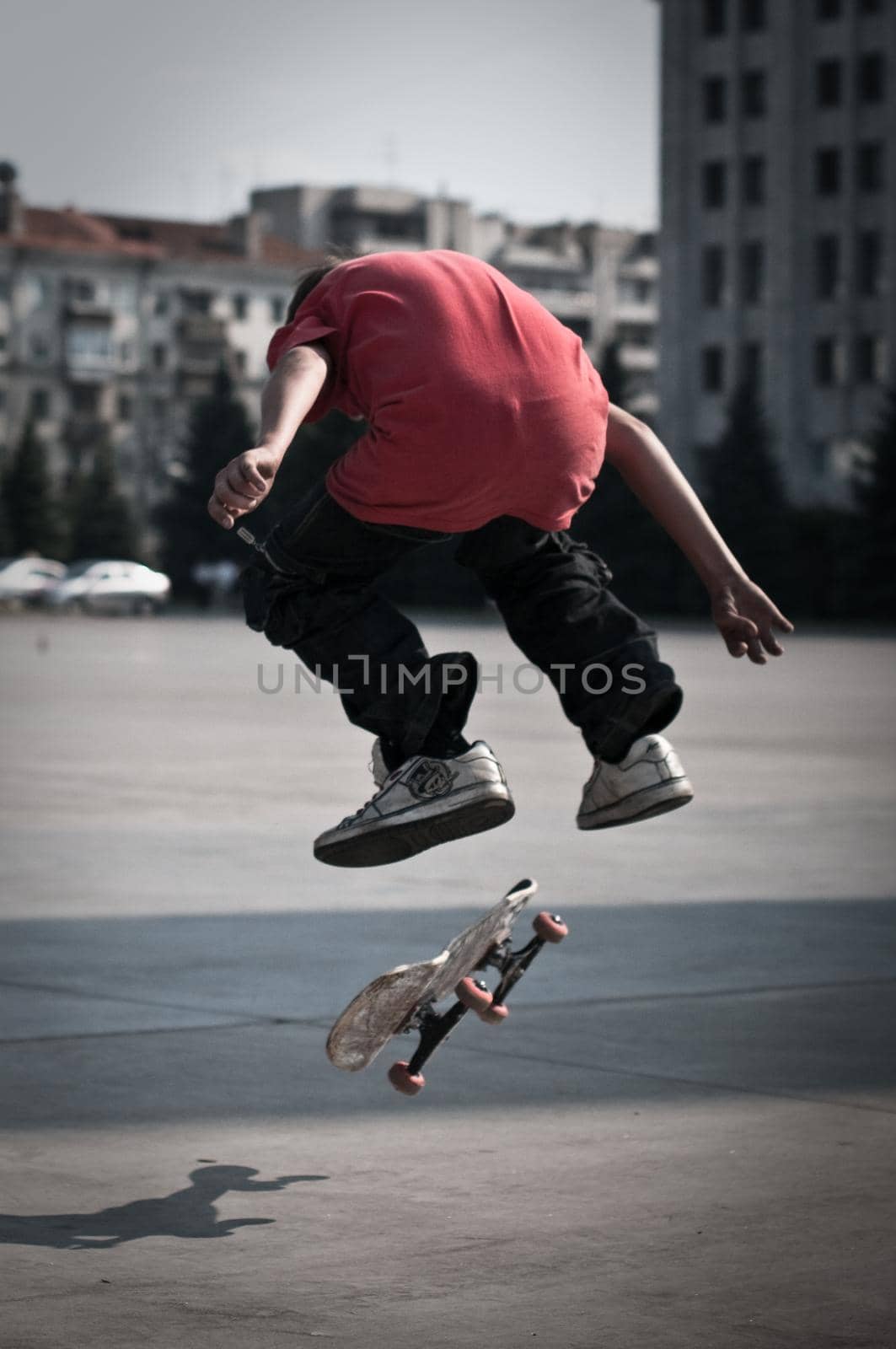 young skater perfoming stunt on his board