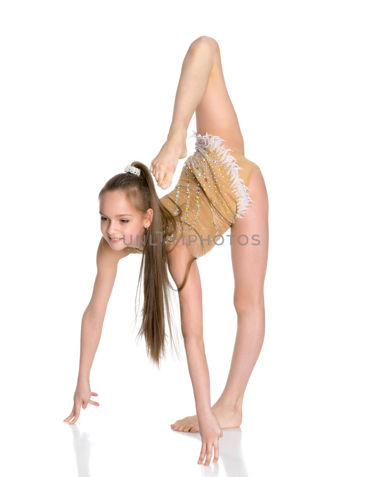 little girl gymnast performs an exercise. Balance on one leg with a grip. Sport concept, gymnastics, fitness. Isolated on white background.