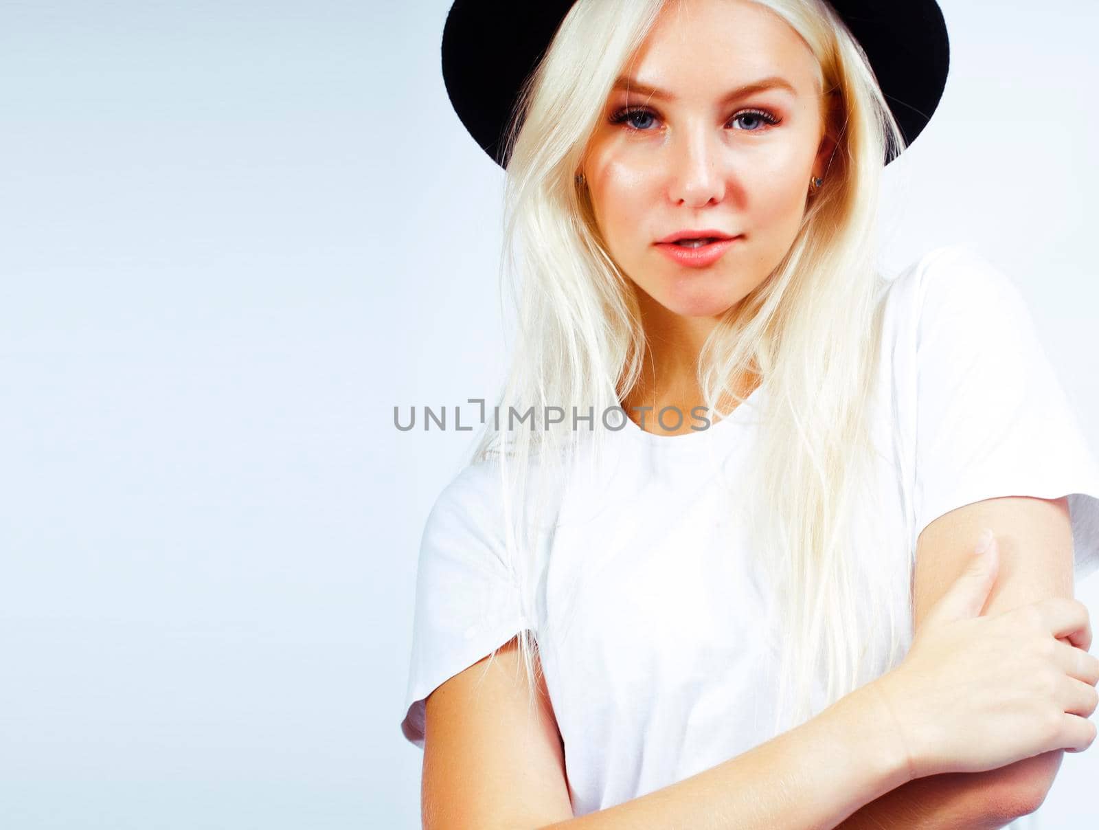 young pretty stylish blond hipster girl in hat posing emotional isolated on white background, lifestyle people concept close up