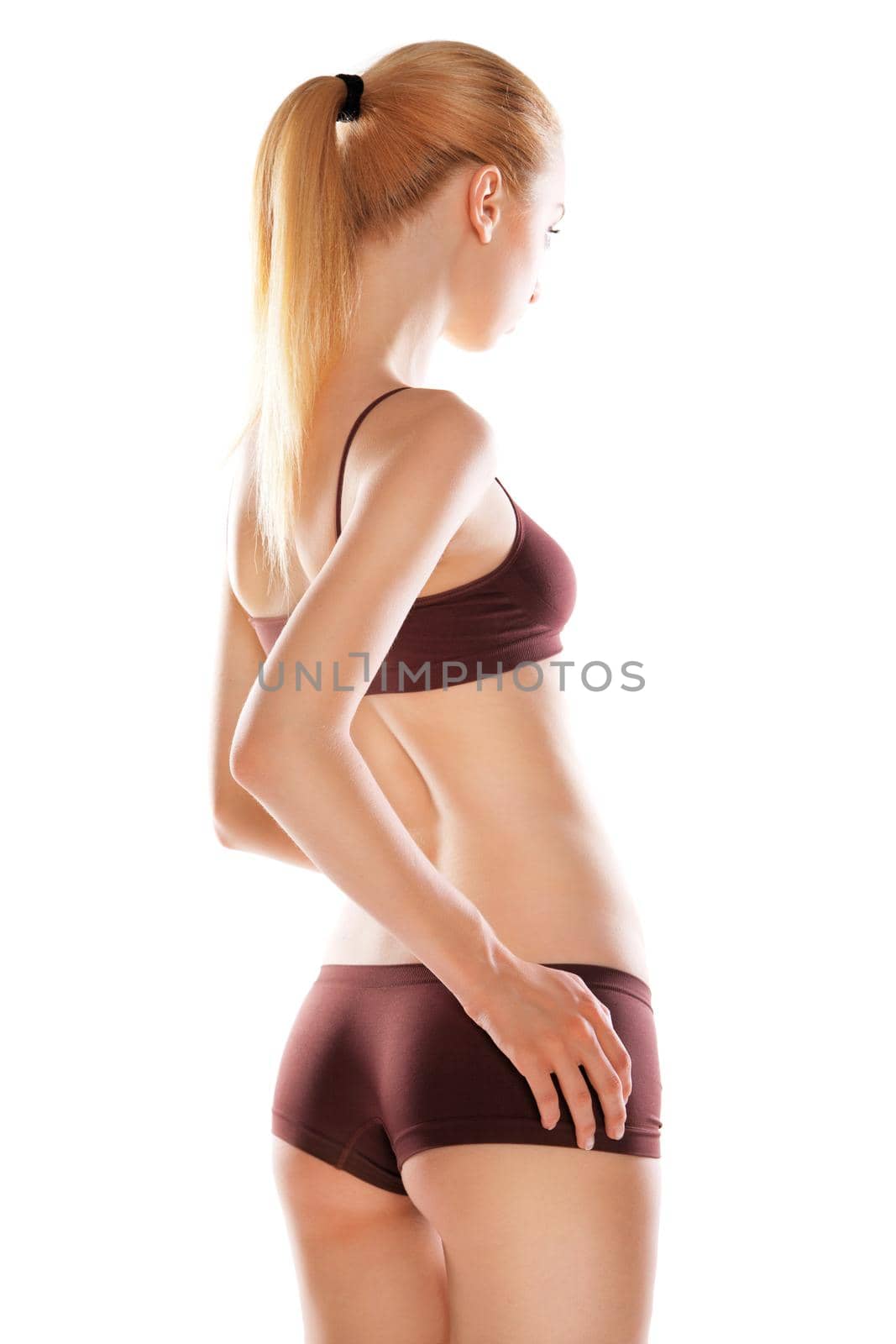 Rear view of beautiful blond caucasian woman with long hairs in sport wear, isolated on white background