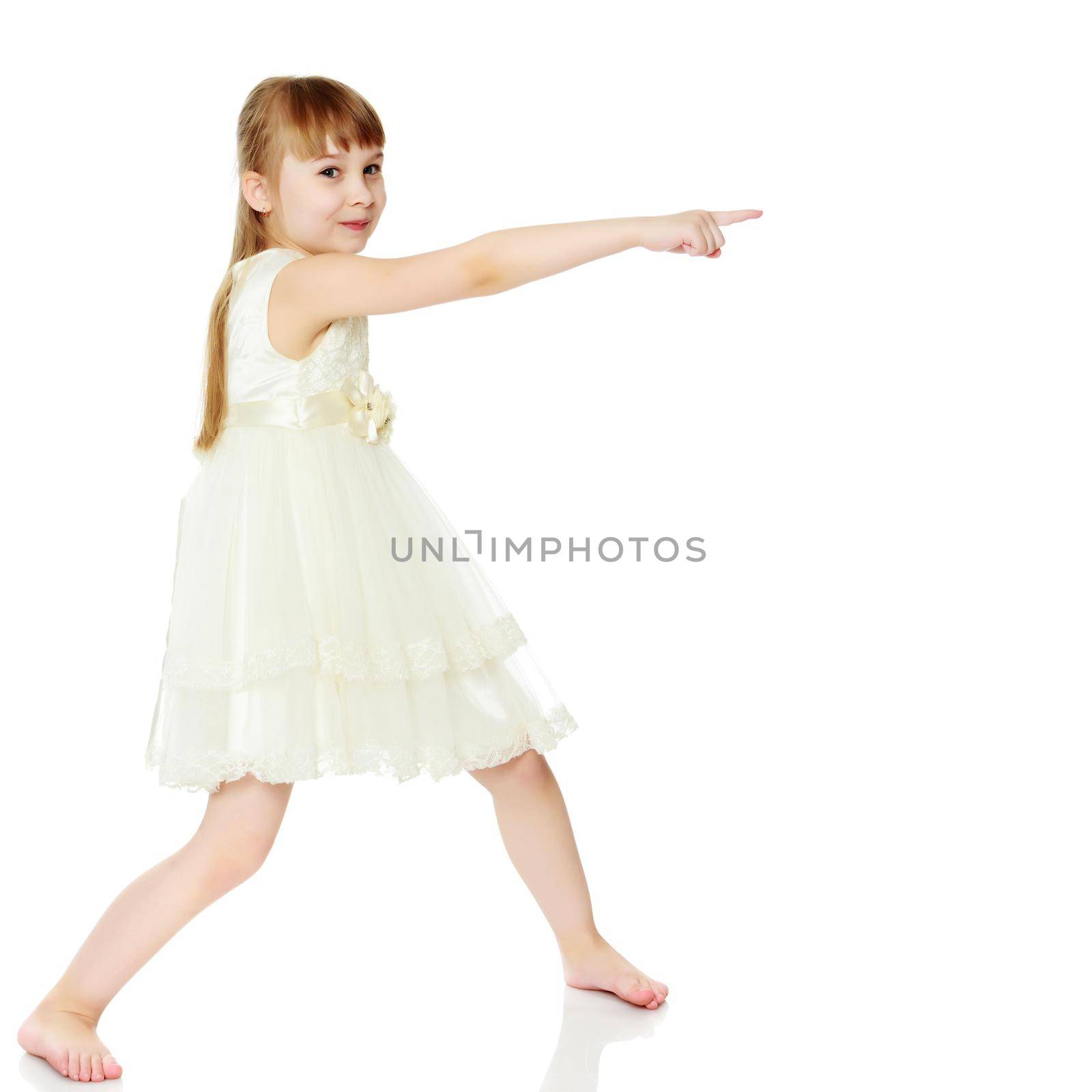 Little girl pointing at something. The concept of family happiness and the development of the child. Isolated over white background