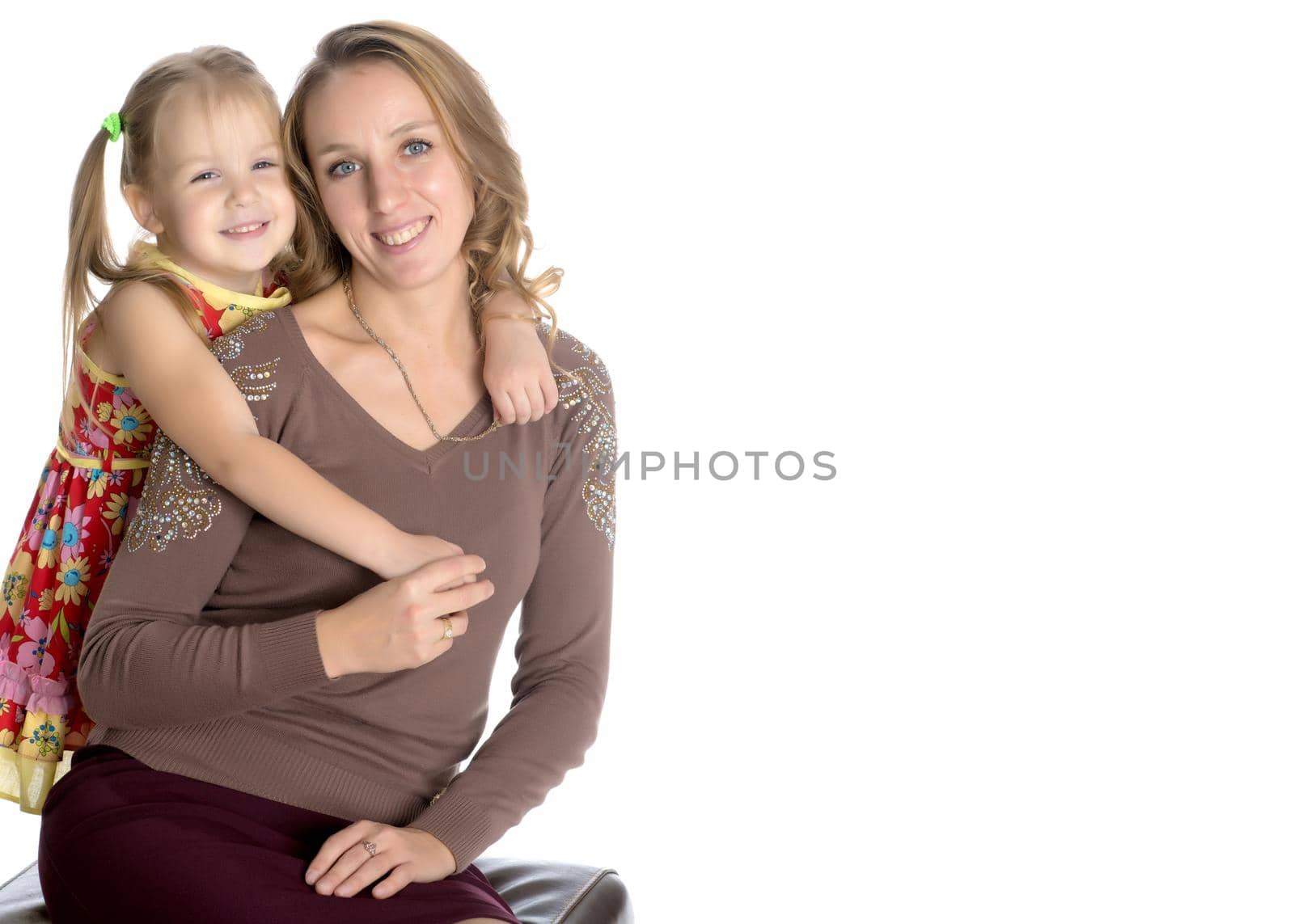 Young mother and little daughter gently embrace. The concept of Happy Childhood, Family Happiness, Raising a Child. Isolated on white background.