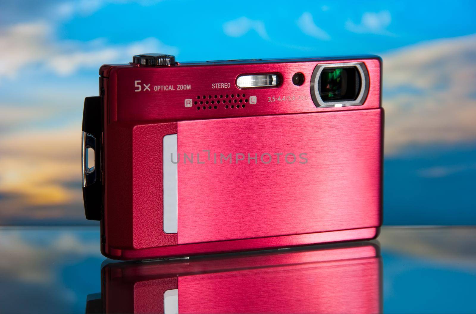photo of the compact digital camera with beautiful background and glass reflection